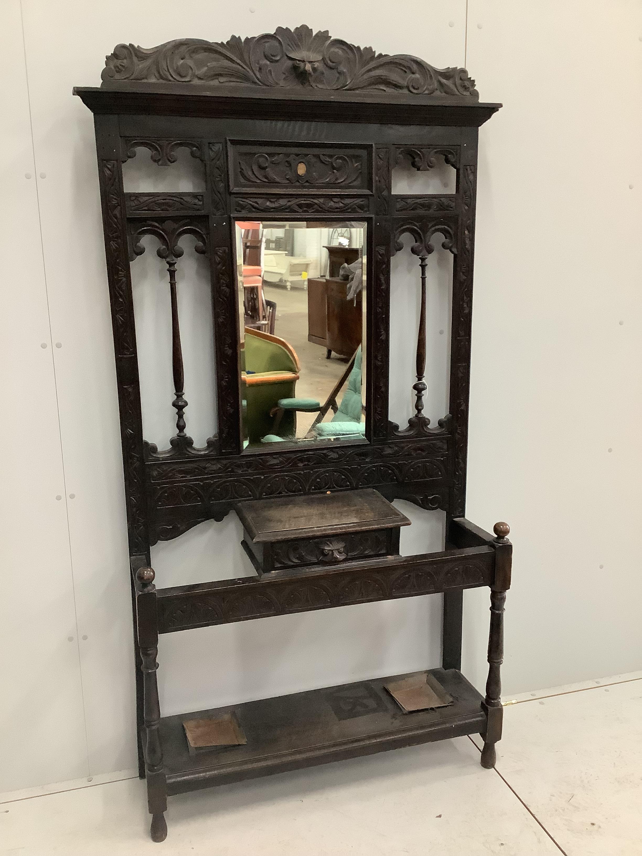 A late Victorian carved oak hallstand, width 107cm, height 210cm